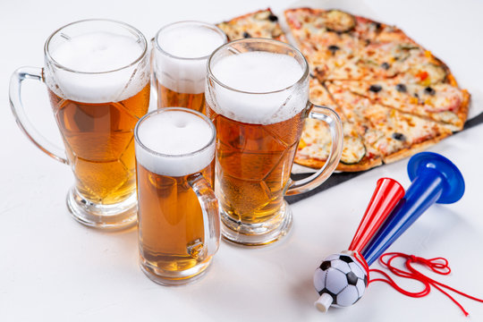 Image of glasses with foam beer, pizza, pipes
