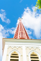 Architectural detail on striking pink church bell tower