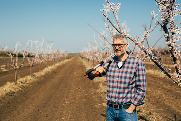 worker posing in orchard