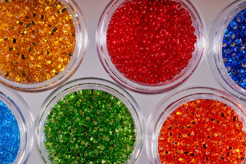 Background of glass beads for needlework. Macro shooting