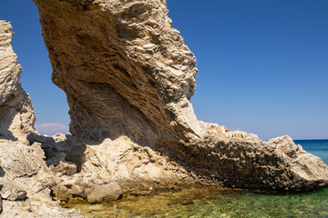 Natural arch on the Mediterranean coast. Rhodes Island, Greece.