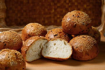 buns for hamburgers sprinkled with seeds lie on the cutting Board