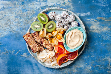 Healthy vegan dessert snacks - protein granola bars, homemade raw energy balls, cashew butter,...