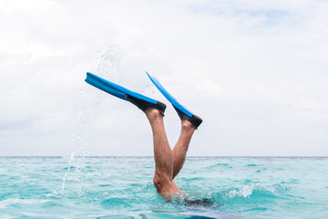 man legs with flippers diving into water © NDStock
