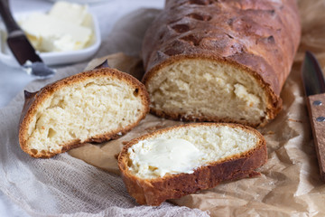 Butter and fresh bread. Simple breakfast on grey concrete background.