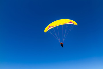 paraglider flying high in the sky