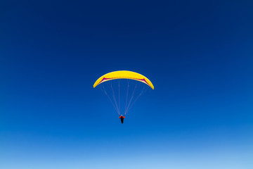 Fototapeta na wymiar paraglider flying high in the sky
