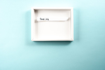 Concept of good job or searching new job. White opened box framing the text "good job" on blue background