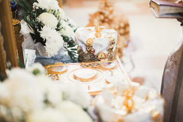 Golden crowns lying on the table in church