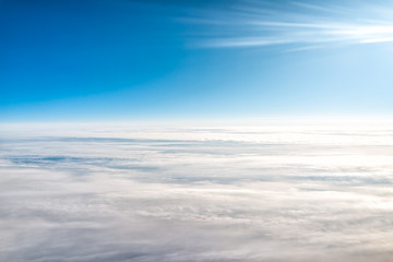 White blue sky with aerial view from window plane high angle during sunny day with clouds covering horizon