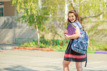 Girl schoolgirl teenager 11-14 years old, summer city after school lessons.