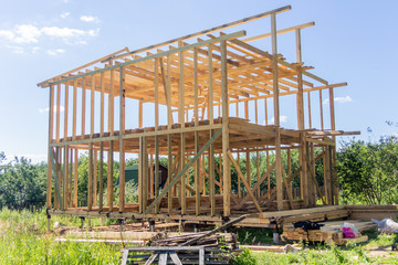 Obraz premium wooden interior frame of a new house under building, architectural residential construction stick built home framework.