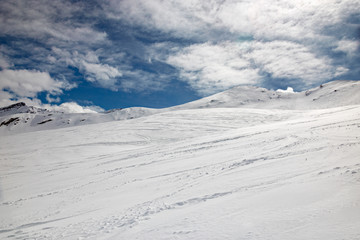 Fototapeta na wymiar Winter panoramic view of a snowy mountain slope, of a mountain, in Switzerland.