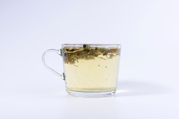 green herbal tea in a transparent cup isolated on white background