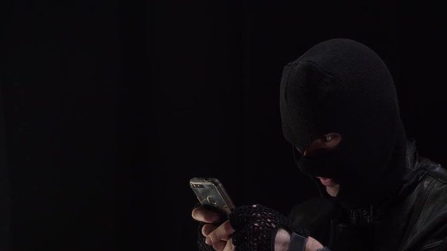 Hacker hacking using a smartphone. Copyspace