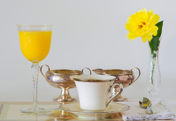Coffee, Juice and Sterling Silver Serving Pieces on Neutral Background with Copy Space
