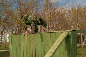 soldier jumps over an obstacle.