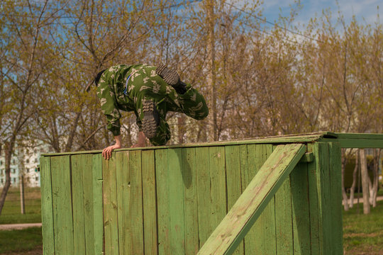 soldier jumps over an obstacle.