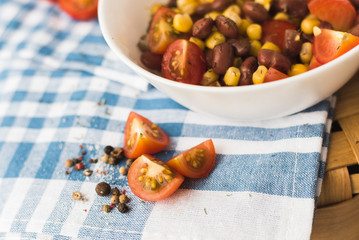 Salad of red beans, yellow corn, crackers. Picnic basket and a beautiful blue towel.