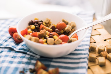 Salad of red beans, yellow corn, crackers. Picnic basket and a beautiful blue towel.
