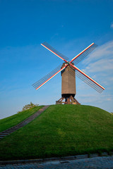 Obraz premium Sint-Janshuismolen Sint-Janshuis Mill windmill in Bruges on sunset, Belgium