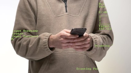 A young male hacker with a smartphone in his hands. Green coding appearing on the screen showing the hacking process.