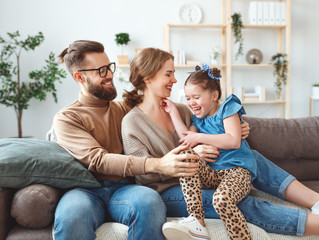 happy family mother father and child daughter laughing   at home  .