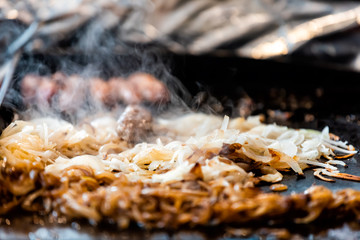 Fast food counter grill background with cooking fresh onions beef pork meat in truck hot steam closeup and nobody