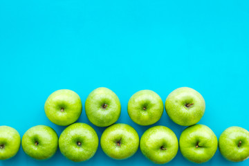 food pattern with green apples on blue background top view space for text