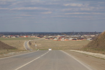 A winding road leads to the next village. On which cars go.