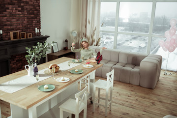 Woman staying alone in spacious apartment on birthday