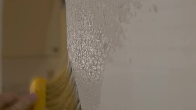 Applying stucco plaster to a wall - close up