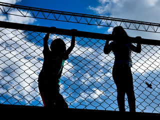 silhouettes of children behind the mesh