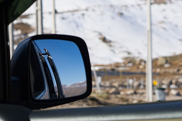 Rearview mirror on van in the mountains