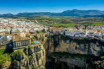 Fototapeta premium Ronda Spain aerial view of medieval hilltop town surrounded by walls and towers with famous bridge over gorge