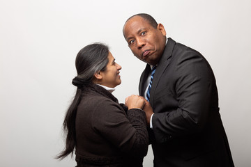 Playful Mixed Race Couple on Light Gray Background