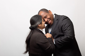 Happy Mixed Race Couple Posing Together on Light Gray Background
