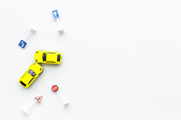 Car insurance concept with car toys on white background top view copyspace
