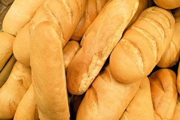Crusty bread baguette in a bakery. Fresh organic pastry at a local market. Traditional France cuisine