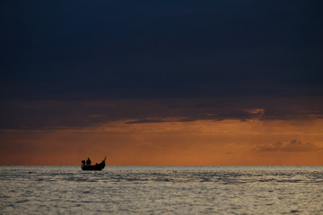 Silhouette fishing boat in the sea