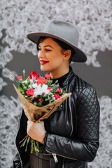 Cool girl holding a flower bouquet