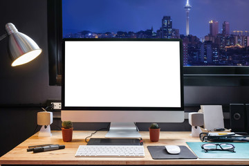 Naklejka premium Graphic designer's workspace with a pen tablet, a computer and white backgroud for text with beautiful view of Cityscape in Macau from Window