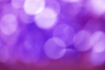 Defocused Bokeh twinkling lights Vintage background. Festive background with natural bokeh and bright lights.