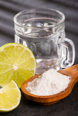 Glass of water, lemon, soda bicarbonate - Citrus × latifolia