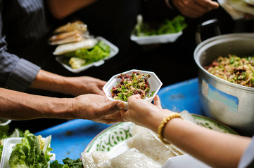 The hand holding food is a hope for the poor to get the opportunity to eat.
