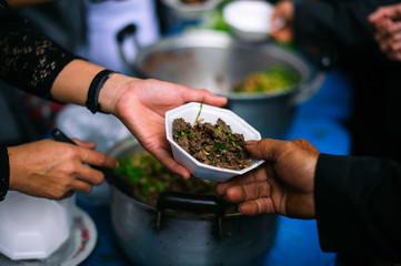 The hand holding food is a hope for the poor to get the opportunity to eat.