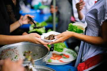 Volunteers collaborated to provide food to beggars with compassion.