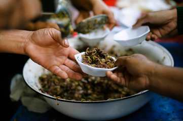 Charity food : Feeding the poor to hands of a beggar. Poverty concept
