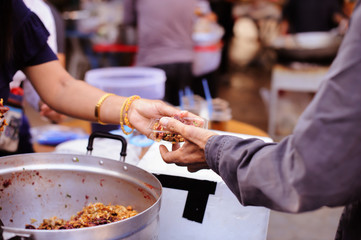 Charity concept : Feeding the poor to help each other in society.