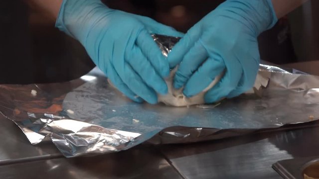 Preparing Mexican Burrito for customer.